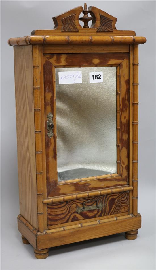 A pine and faux bamboo small mirrored cabinet